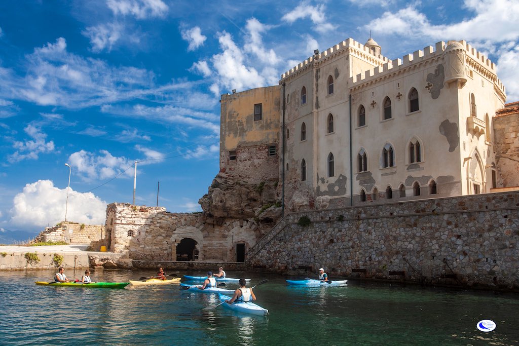 Canoe nel porto vecchio isola di pianose con palazzo della Specola